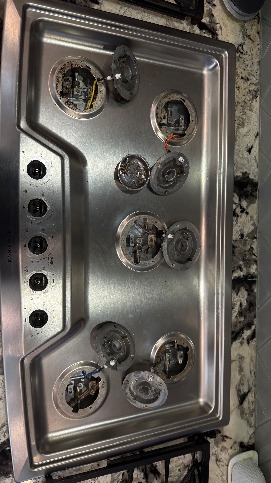 Monogram gas cooktop disassembled for repair