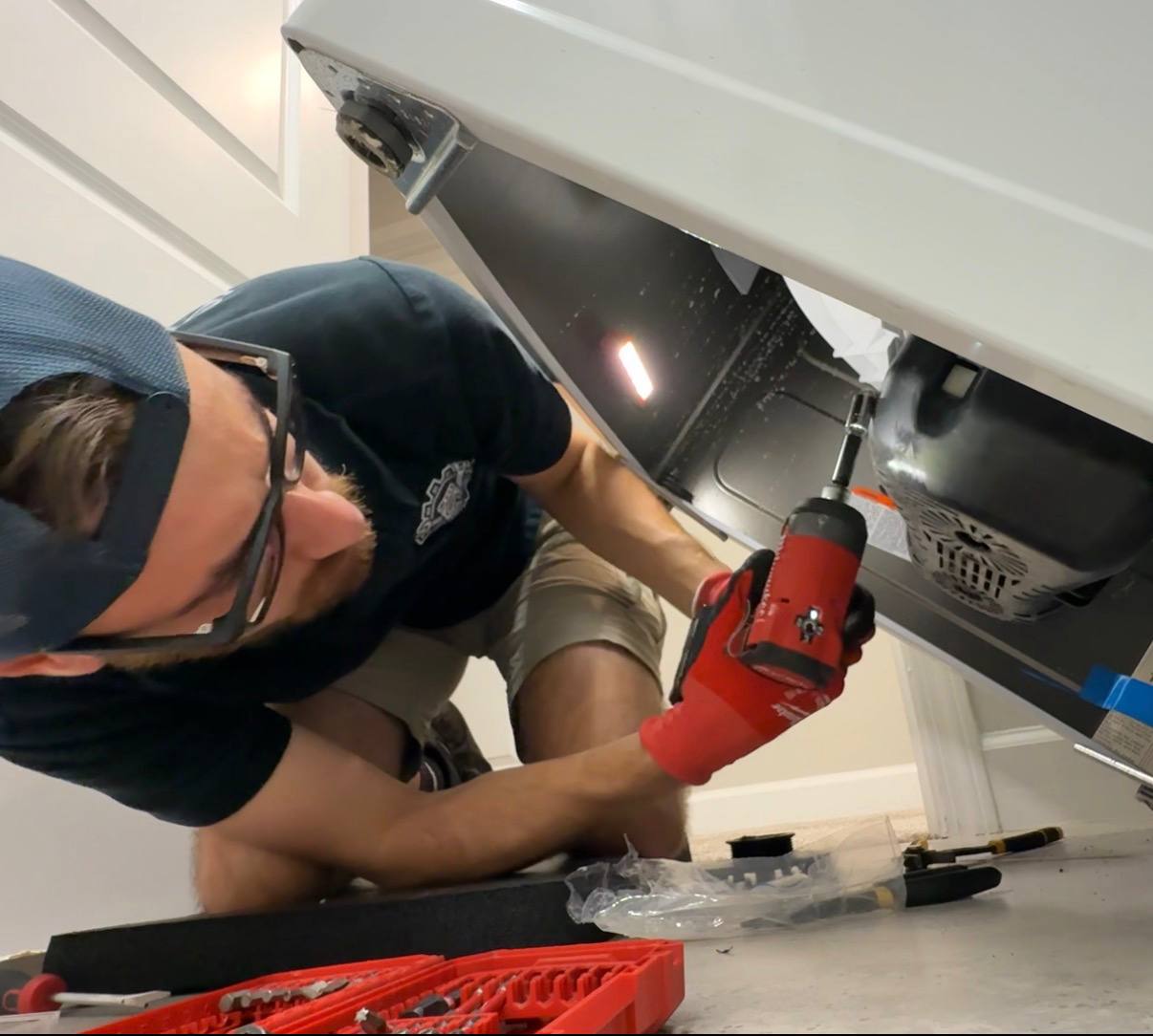 Technician performing detailed appliance repair work